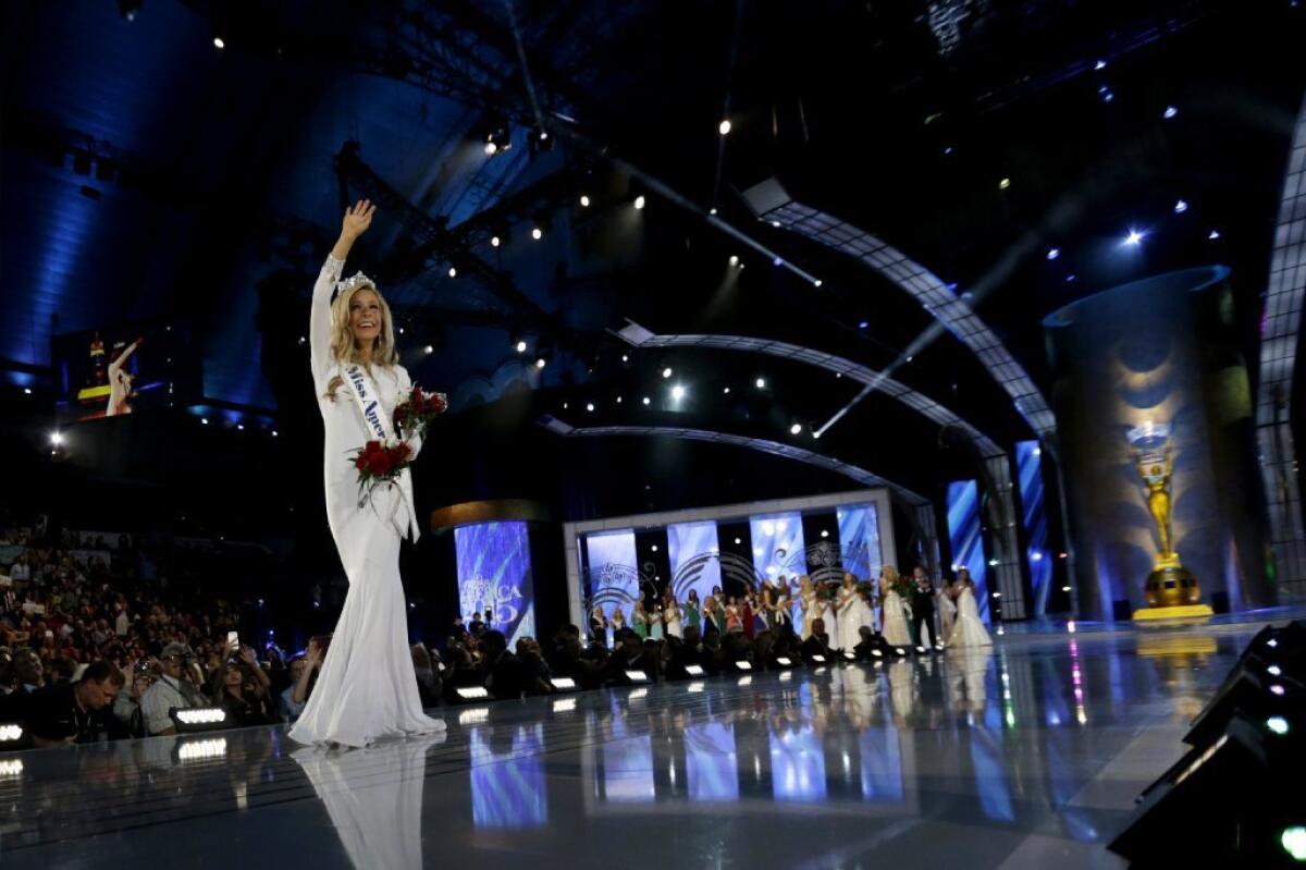 Miss America 2015, New York's Kira Kazantsev, waves to the crowd after getting her crown. Domestic violence questions and answers figured front and center in the competition.