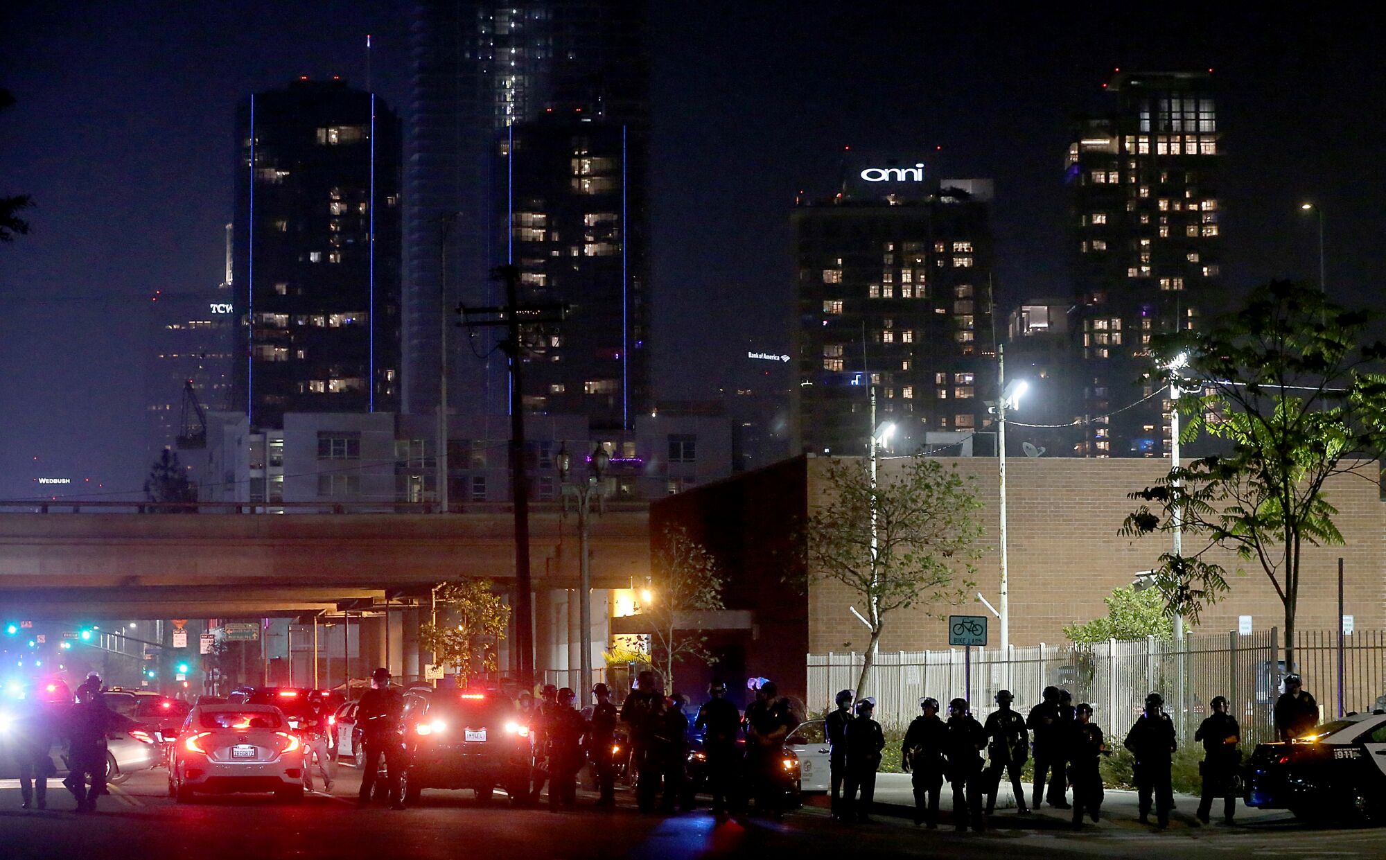 Police take positions along Figueroa Street in downtown Los Angeles on Tuesday night.