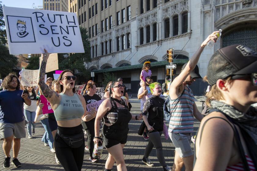 SAN ANTONIO, TX- JUNE 24, 2022: Hundreds of protesters marched in 100 degree heat downtown against the Supreme Court's decision to overturn Roe v. Wade on June 24, 2022 in San Antonio, Texas.(Gina Ferazzi / Los Angeles Times)