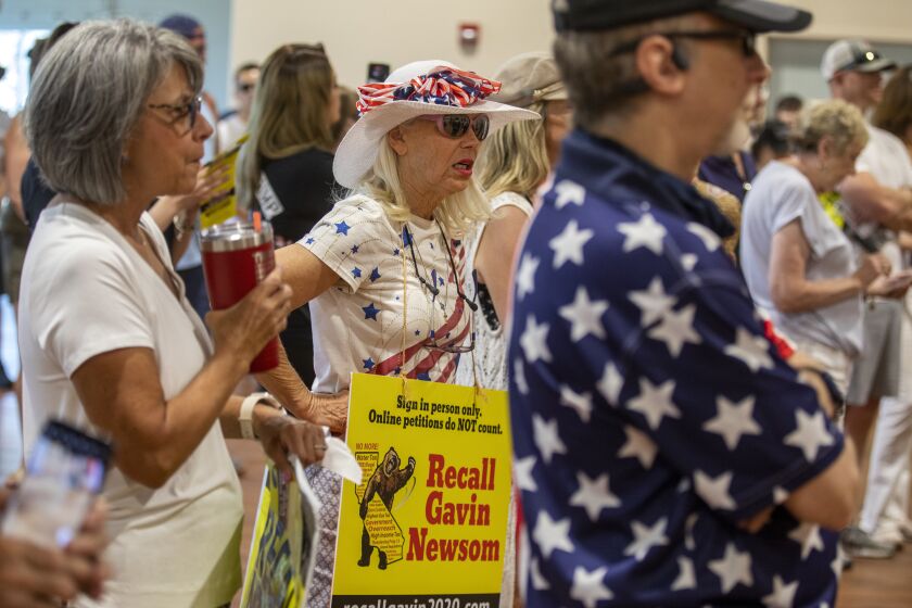SANTA CLARITA, CA - AUGUST 15: Vicky Abramson, middle, of Valencia is attending a rally at the Santa Clarita Activities Center on Sunday, Aug. 15, 2021 in SANTA CLARITA, CA. She is attending the "Yes on Recall" - a rally in support of the recall against Gov. Gavin Newsom. The stop will mark the third and final stop in a two-day tour in support of the recall across Southern California. (Francine Orr / Los Angeles Times)
