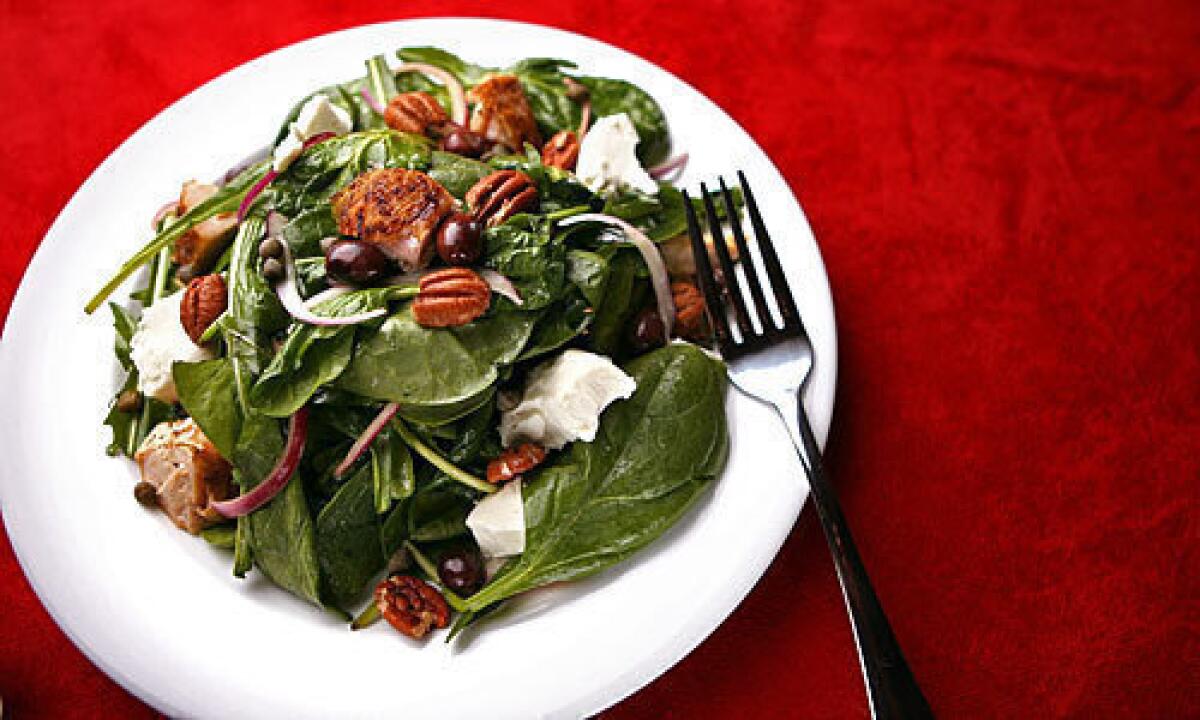 Pecans and goat cheese add texture and flavor to chicken, spinach, arugula and dandelion greens.
