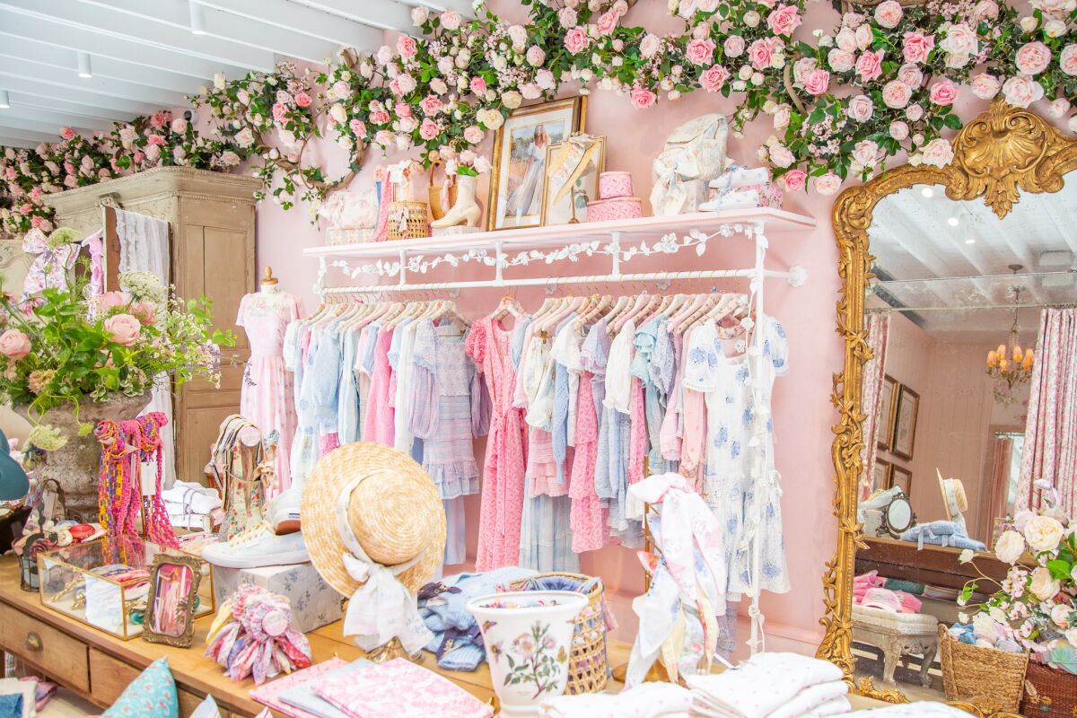 The interior of LoveShackFancy's flagship is filled with flowers, Sanderson chintz wallpaper and custom curtains