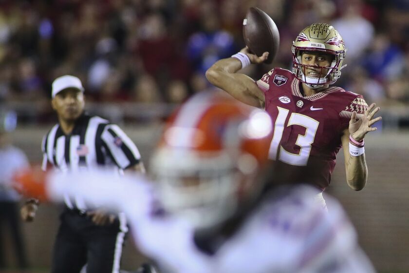 Florida State quarterback Jordan Travis (13) throws in the first quarter of an NCAA college football game against Florida, Friday, Nov. 25, 2022, in Tallahassee, Fla. (AP Photo/Phil Sears)