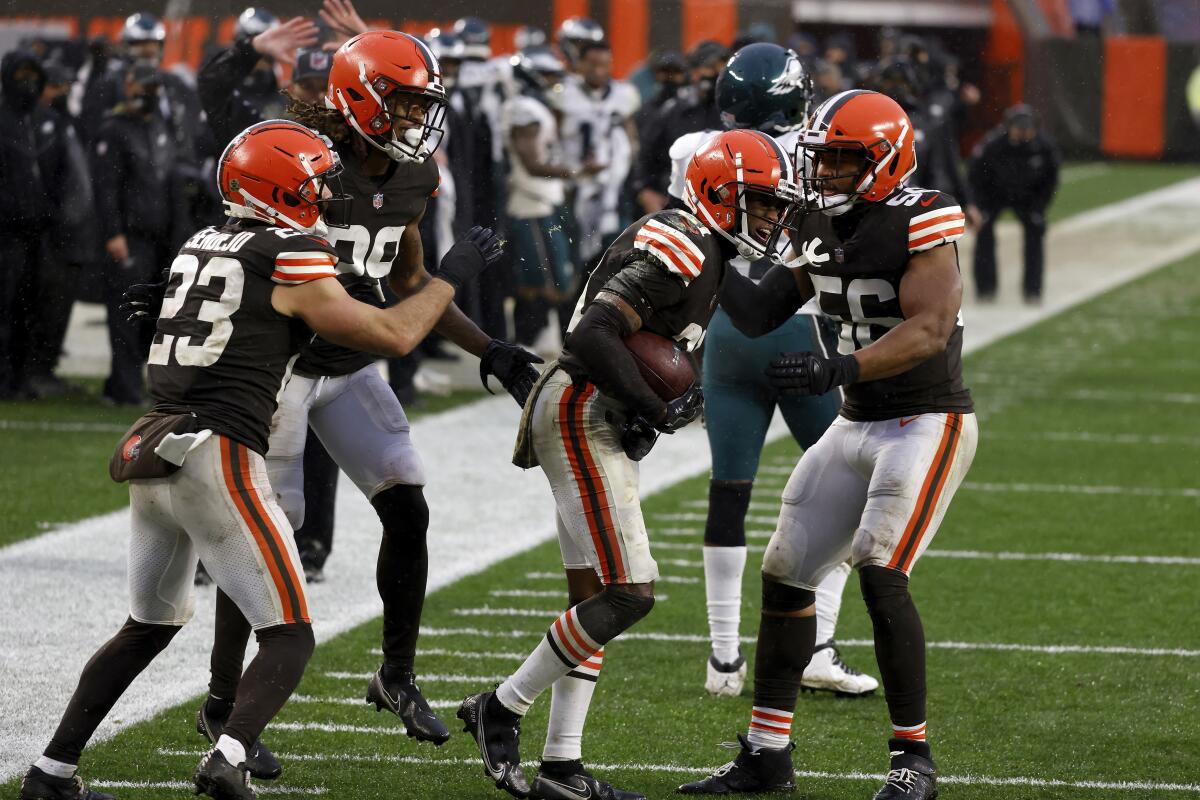 Cleveland Browns cornerback Denzel Ward, center, is congratulated by teammates.