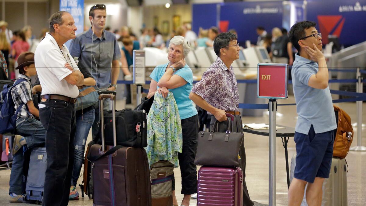 Delta passengers in Salt Lake City stand in line this month as the carrier tried to recover from a global computer outage.