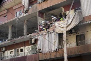 Residents and rescuers check a building that was hit by an Israeli airstrike in Beirut's southern suburbs, Tuesday, Sept. 24, 2024. (AP Photo/Hassan Ammar)