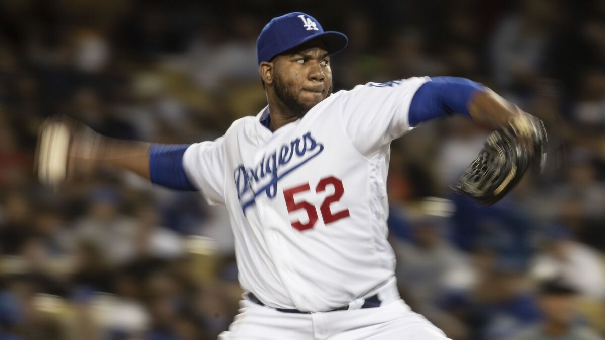 Dodgers pitcher Pedro Baez delivers during the seventh inning of a 5-4 loss to the Arizona Diamondbacks.