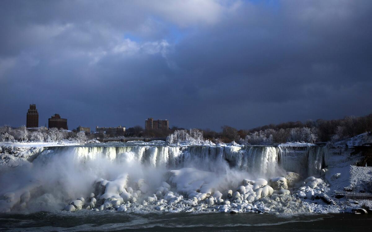 Water flows over the American Falls as ice forms in this view from Niagara Falls, Ontario.
