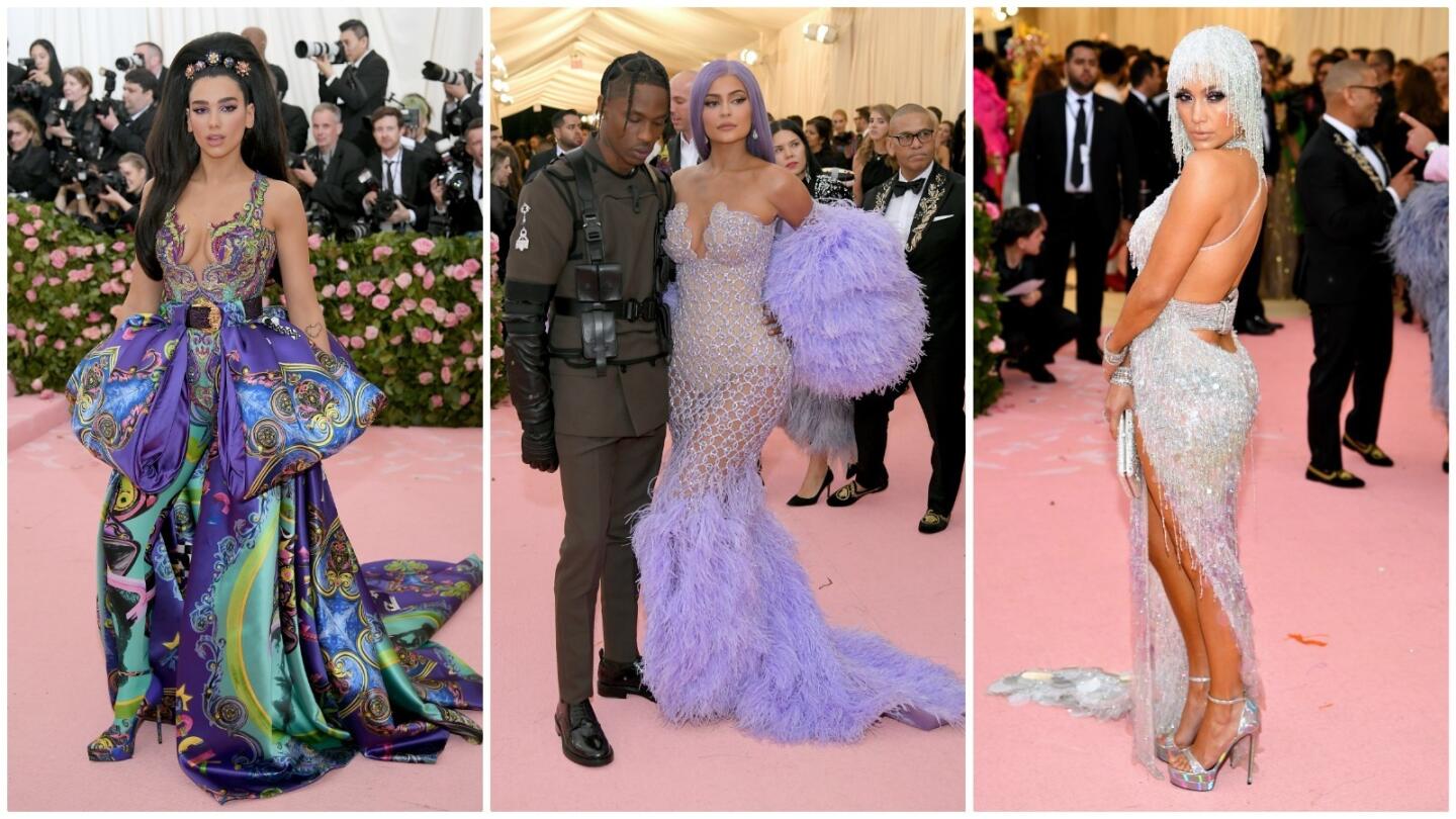 Dua Lipa (in Versace), from left, Travis Scott with Kylie Jenner (in Versace) and Jennifer Lopez (in Versace) on the 2019 Met Gala red carpet.