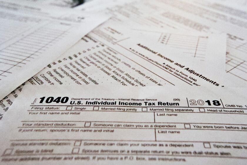 This Wednesday, Feb. 13, 2019, in Zelienople, Pa., shows multiple forms printed from the Internal Revenue Service web page that are used for 2018 U.S. federal tax returns. The government says that the average tax refund and the total amount of refunds issued have declined for the second straight week. The declines have become a political issue, as Democrats contend they show how the new Republican-written tax law hurts middle-class people. (AP Photo/Keith Srakocic)
