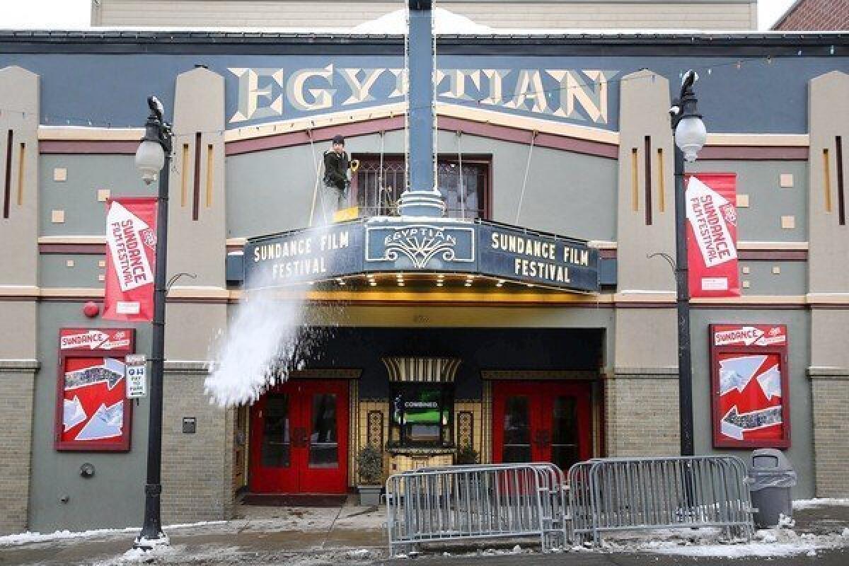 Peter Mayhew, technical director of the Egyptian Theatre, shovels snow off the marquee before the start of the 2013 Sundance Film Festival.