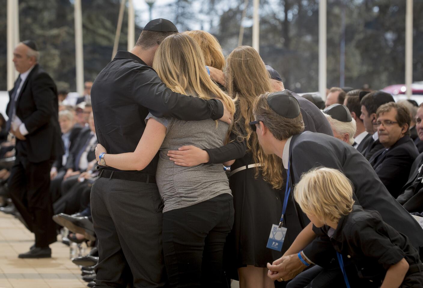 Members of former Israeli President Shimon Peres' family embrace at his funeral at Mt. Herzl Military Cemetery in Jerusalem.