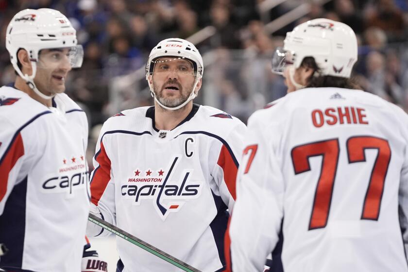 Washington Capitals' Alex Ovechkin, center, talks to T.J. Oshie, right, and Max Pacioretty during the third period in Game 2 of the team's NHL hockey Stanley Cup first-round playoff series against the New York Rangers, Tuesday, April 23, 2024, in New York. (AP Photo/Frank Franklin II)