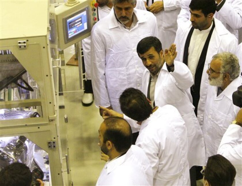 Iranian President Mahmoud Ahmadinejad, second right, gestures, as he visits Iran's Fuel Manufacturing Plant (FMP), a new facility producing uranium fuel for a planned heavy-water nuclear reactor, just outside the city of Isfahan, 255 miles (410 kilometers), south of Tehran, Iran, Thursday, April 9, 2009. The West fears the reactor could eventually be used for producing a nuclear weapon. The plant will produce pellets of uranium oxide to fuel the heavy-water research reactor, which is scheduled to be completed in 2009 or 2010. (AP Photo/Vahid Salemi)