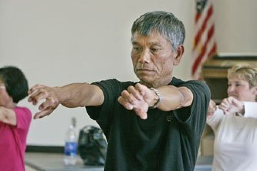 Chieu Hoang (center) and others did warm-up exercises in tai chi class at Bayside Community Center. The center has struggled to maintain its wide menu of programs. (Peggy Peattie / Union-Tribune)