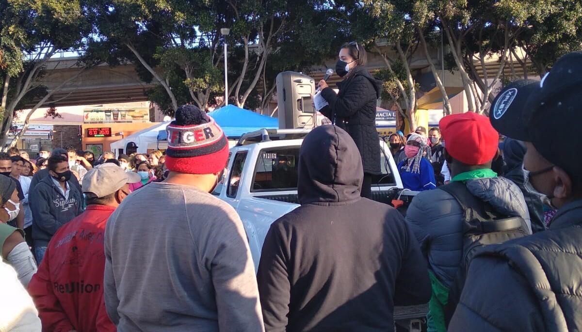 Erika Pinheiro litigation director at Al Otro Lado addresses a group of asylum seekers in Tijuana.