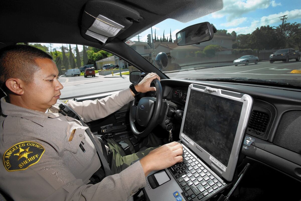 Deputy Charlie Cam of the Los Angeles County Sheriff's Department has the only patrol car at the La Mirada substation that is equipped with ASAP, a four camera roof-mounted system that constantly scans for and photographs the license plates of nearby cars.
