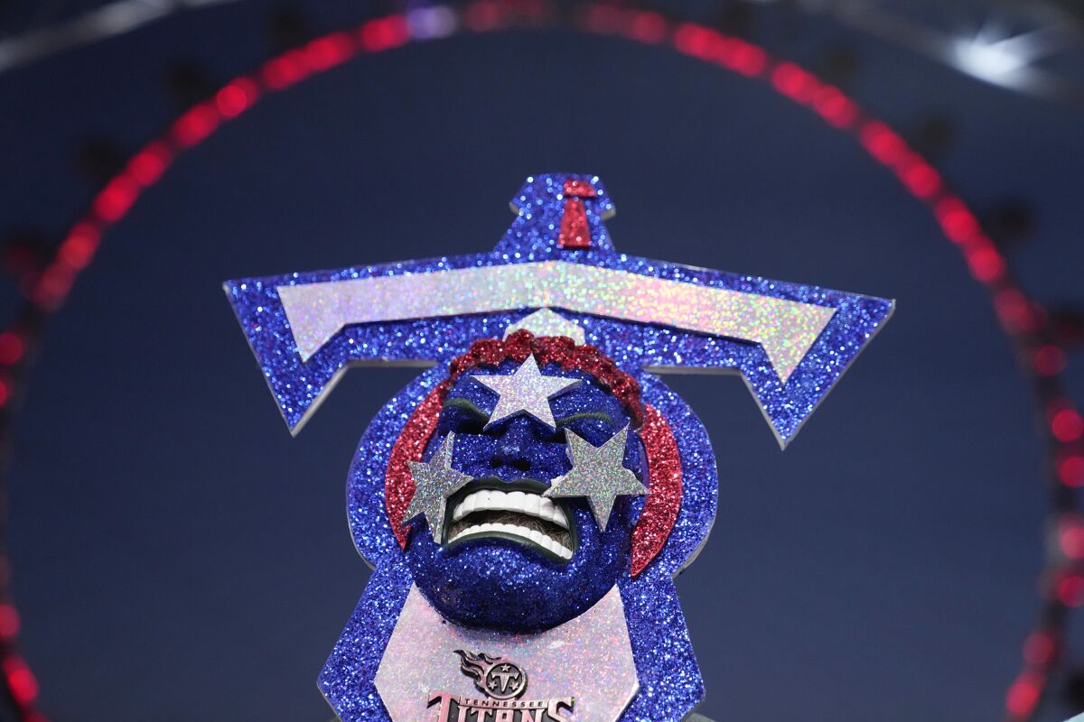 A Tennessee Titans fan watches the announcements on the stage during the third round of the NFL football draft Friday, April 29, 2022, in Las Vegas. (AP Photo/John Locher)