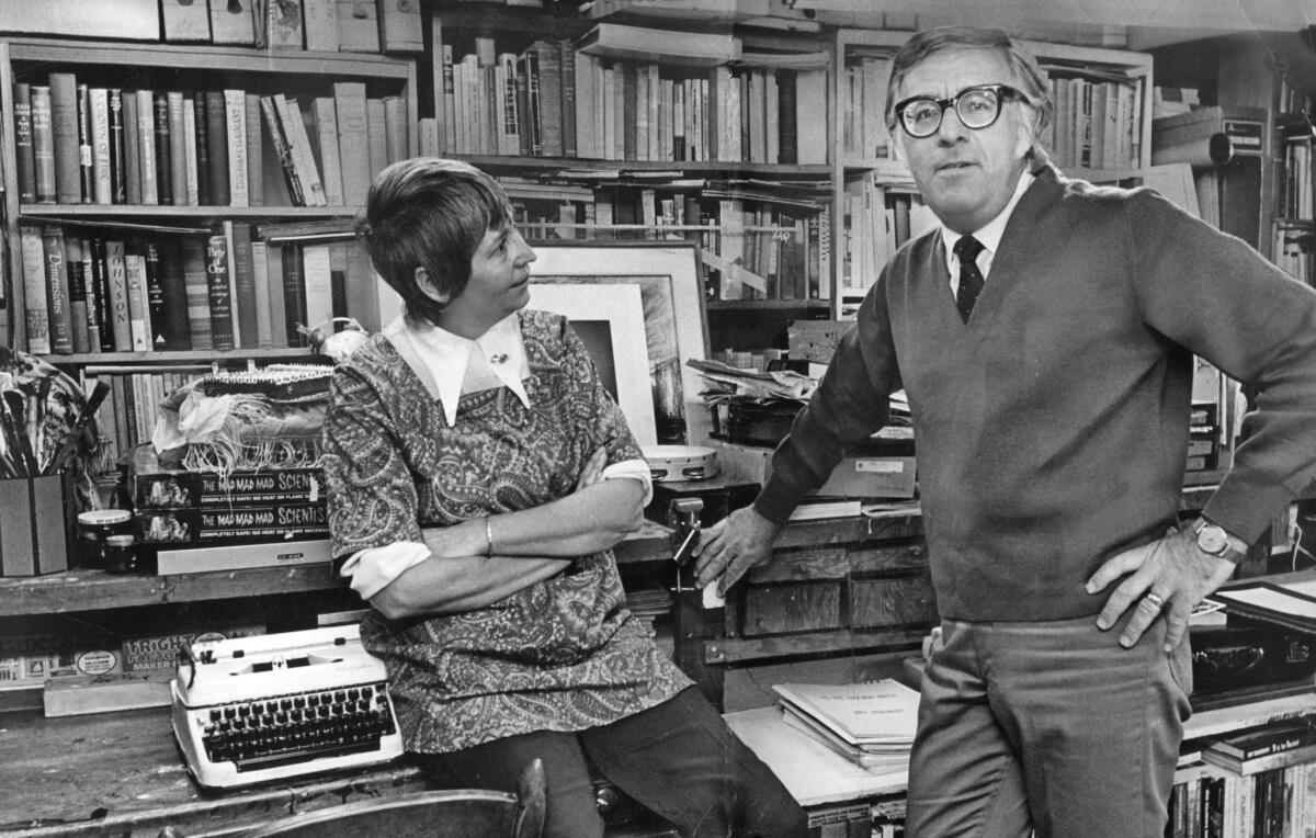 Ray Bradbury at home with his wife, Maggie, in 1970 in a room lined with books.