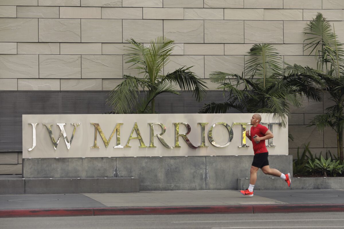 A man jogs past a Marriott sign