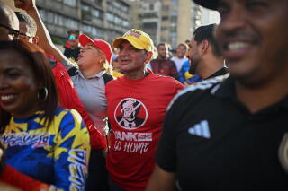 A supporter of Venezuela wearing a t-shirt depicting US President Donald Trump and the slogan "Yankee go home"
