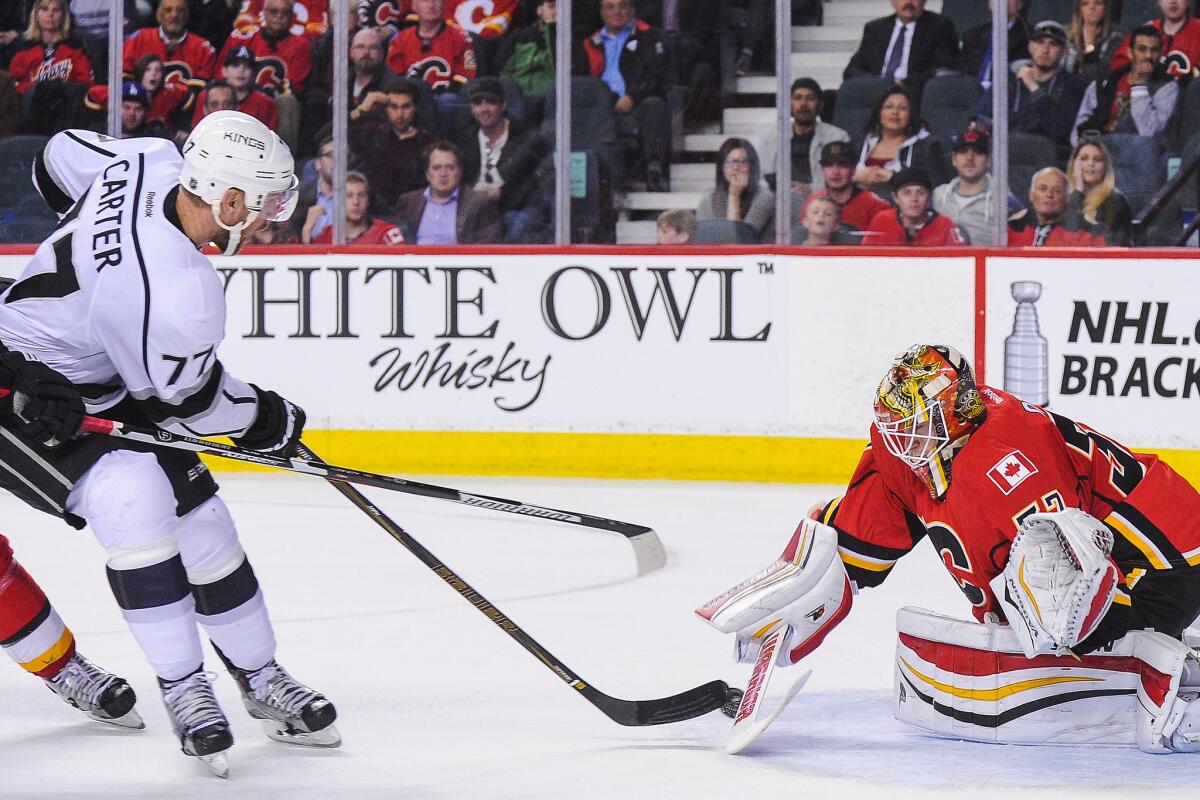 Jeff Carter scores on the Flames 40 seconds into overtime to give the Kings a 5-4 win in Calgary on April 5.