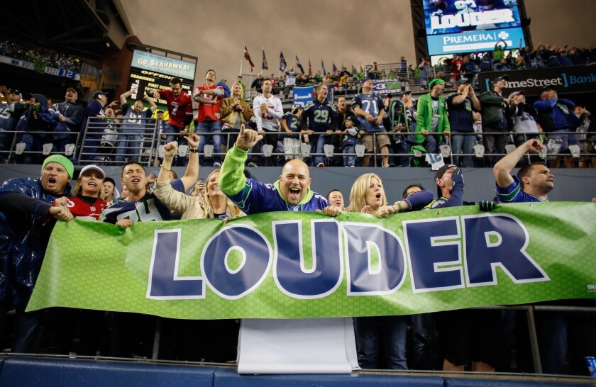 Fans cheer during Sunday's game between the Seattle Seahawks and the San Francisco 49ers at CenturyLink Field.