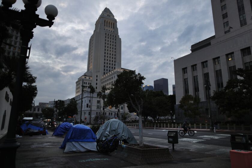 LOS ANGELES, CA - JANUARY 17, 2022: A homeless encampment sits in the shadow of City Hall off Main Street on January 17, 2022 in Los Angeles, California. Mayoral candidate Karen Bass wants to convert the vacant St. Vincent Medical Center near downtown into a housing facility for the homeless.(Gina Ferazzi / Los Angeles Times)
