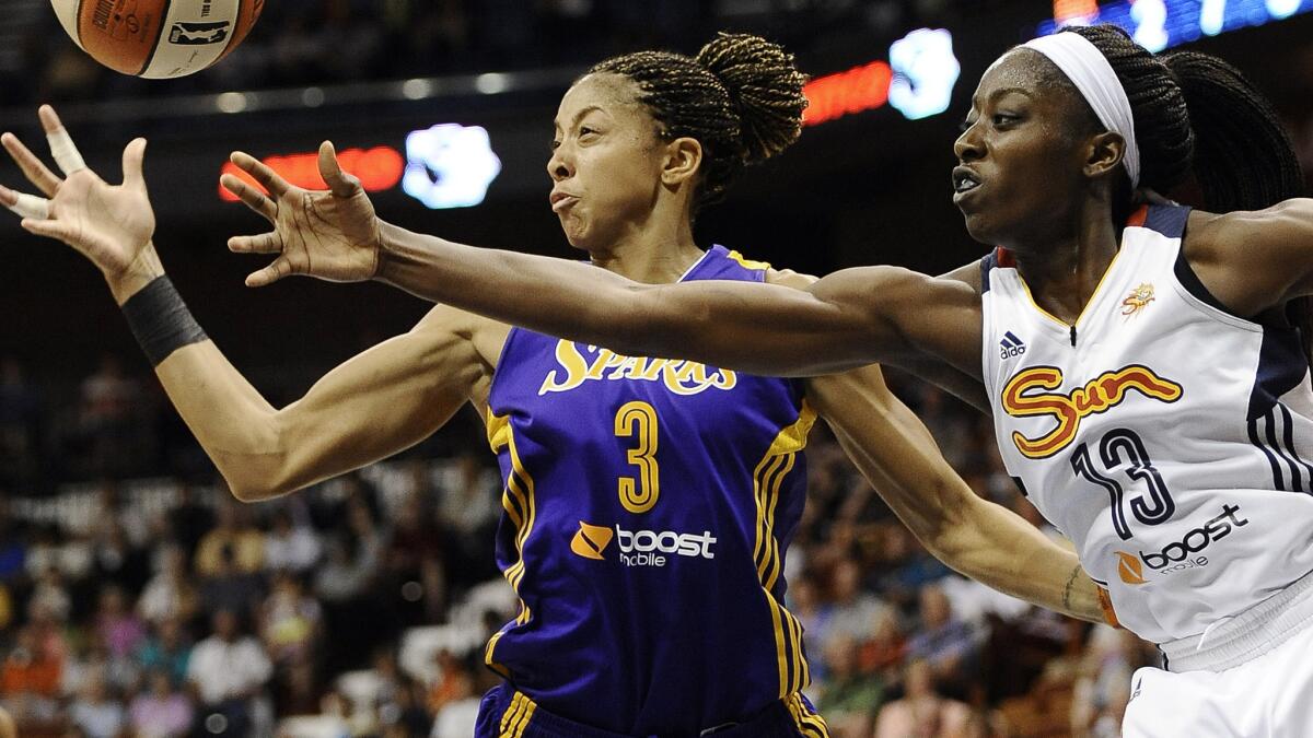 Sparks star Candace Parker, left, and Connecticut's Chiney Ogwumike battle for the ball during the Sparks' win Sunday.