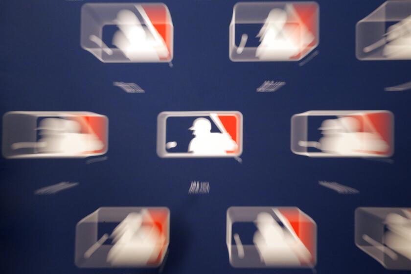 A slow shutter speed and lens zoom creates a blur of the Major League Baseball logos let up at the MLB owners meeting, Thursday, Nov. 19, 2015, in Dallas. (AP Photo/LM Otero)