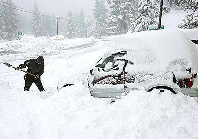 George Groth of Green Valley Lake, south of Big Bear, shovels through over a foot of snow in front of his house off Green Valley Lake Blvd.