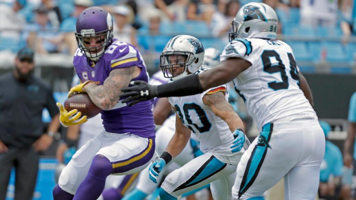 Vikings tight end Kyle Rudolph shields the ball from Panthers defenders during a game on Sept. 25.