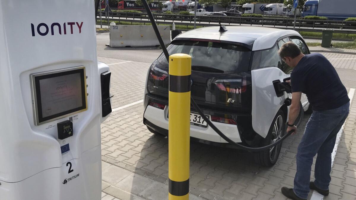 A driver charges his BMW electric vehicle in Niederzissen, Germany.