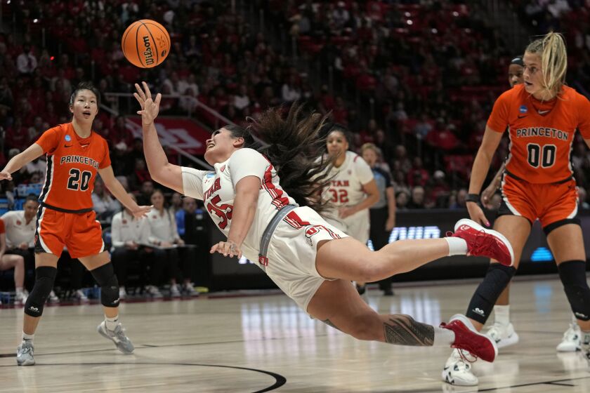 Utah forward Alissa Pili (35) shoots toward the basket as Princeton's Ellie Mitchell (00) and Kaitlyn Chen (20) defend in the first half during a second-round college basketball game in the women's NCAA Tournament, Sunday, March 19, 2023, in Salt Lake City. (AP Photo/Rick Bowmer)