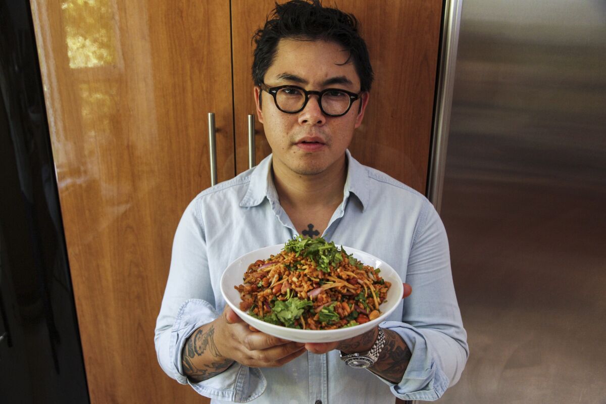 Kris Yenbamroong from Night + Market has been named a Best New Chef by Food & Wine magazine. He's shown holding his famous nam khao tod, a Thai toasted rice salad.