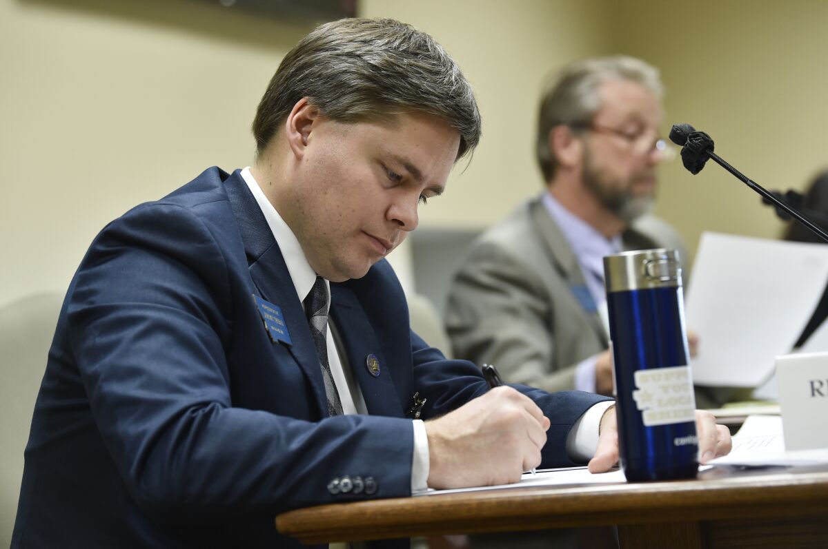 Rep. Jeremy Trebas, R-Great Falls, takes notes during a meeting in the State Capitol in Helena, Mont., on Jan. 14, 2021. Trebas, a Republican, is sponsoring legislation to ban diversity training for state employees if it is aimed at having the employee believe that members of one class are responsible for and must feel guilty for historical injustices. The bill has passed the Montana Senate and was heard by a House committee on Monday, March 20, 2023. (Thom Bridge/Independent Record via AP)
