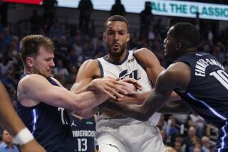 Utah Jazz center Rudy Gobert, center, struggle with Dallas Mavericks guard Luka Doncic, left, and forward Dorian Finney-Smith, right for control of the ball during the second half of Game 5 of an NBA basketball first-round playoff series, Monday, April 25, 2022, in Dallas. (AP Photo/Tony Gutierrez)