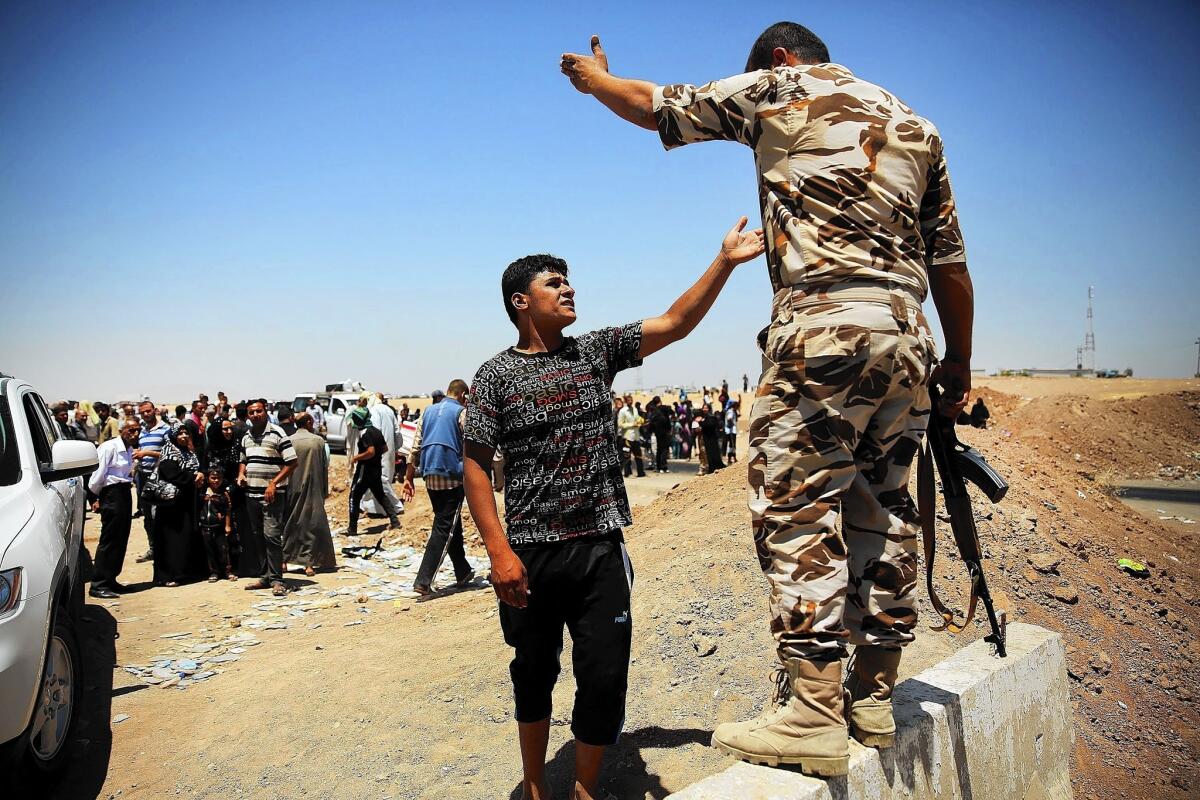 A man argues with a Kurdish soldier in July in the northern city of Khazar as Iraqis who had fled fighting in Mosul and Tall Afar are blocked by Kurdish soldiers from entering a displacement camp. The rise of Islamic State has made Kurds suspicious of Sunni Arabs.