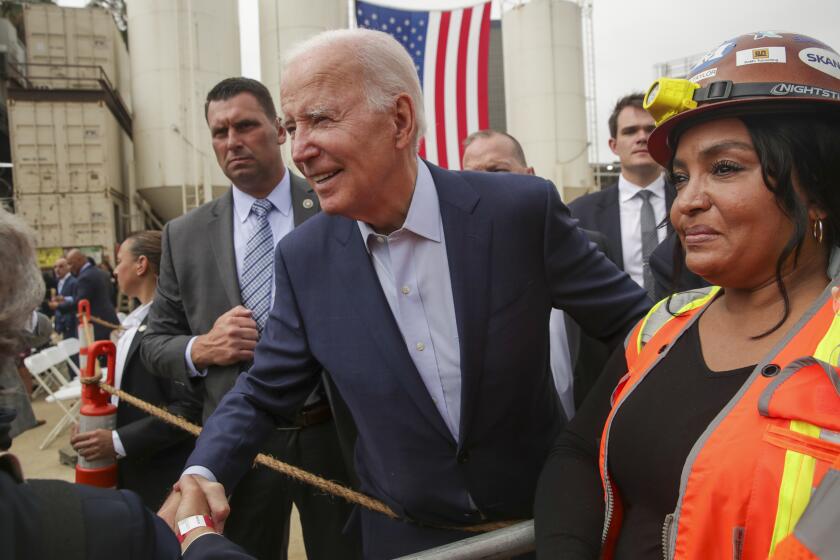Los Angeles, CA - October 13: President Joe Biden chats with construction crew after visiting the construction site for the future terminus of the Metro D (Purple) Line near the West Los Angeles VA Campus on Thursday, Oct. 13, 2022 in Los Angeles, CA. (Irfan Khan / Los Angeles Times)