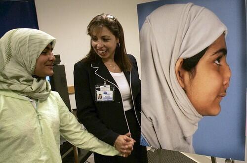 MAIMED: Marwa, left, with Theresa Moussa, a UCLA staffer who has been her translator, companion and surrogate mother, looks at a photograph of herself before the surgeries.