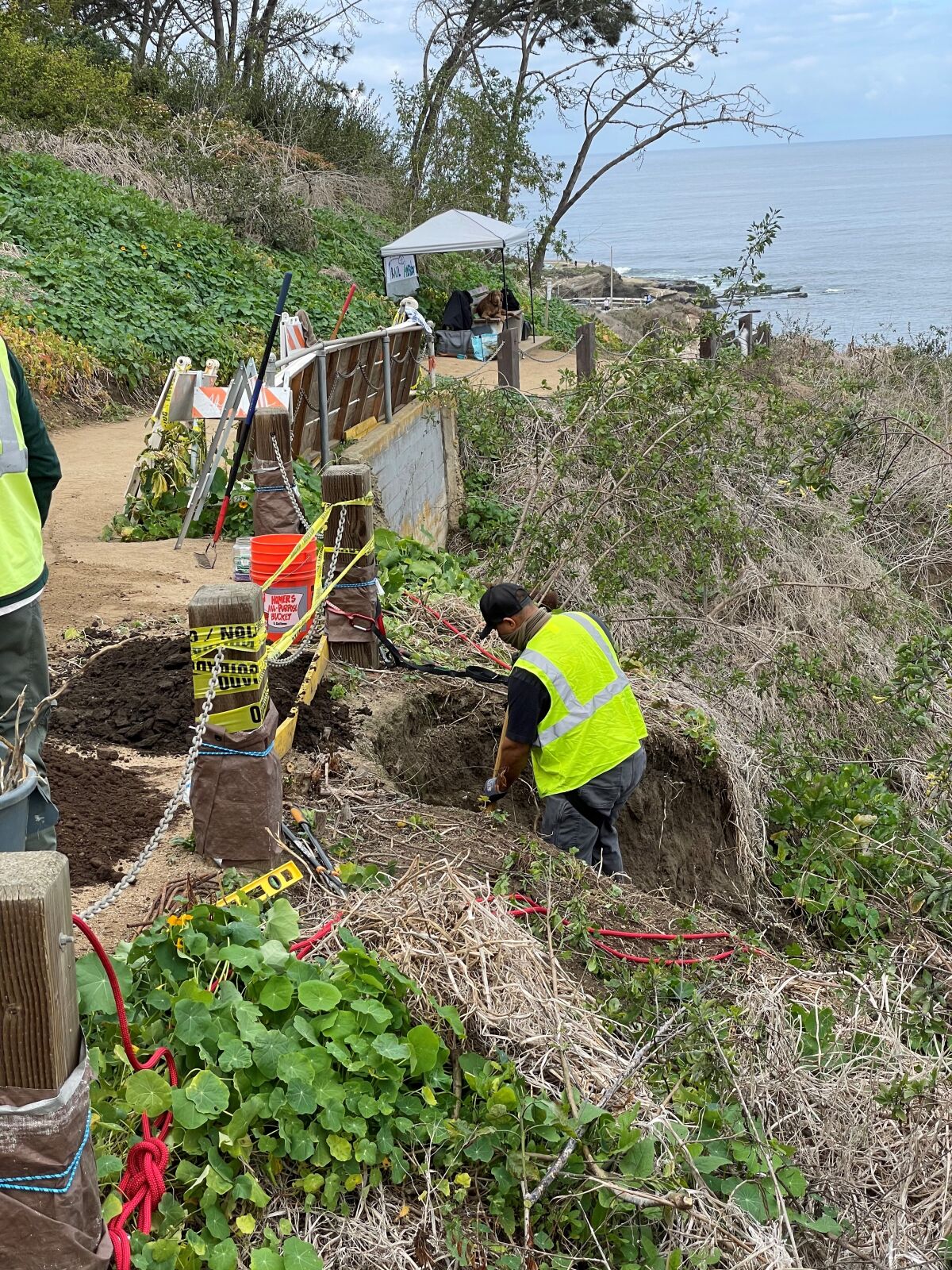 Crew members with Black Sage Environmental work to stabilize a slope next to the Coast Walk Trail this month.