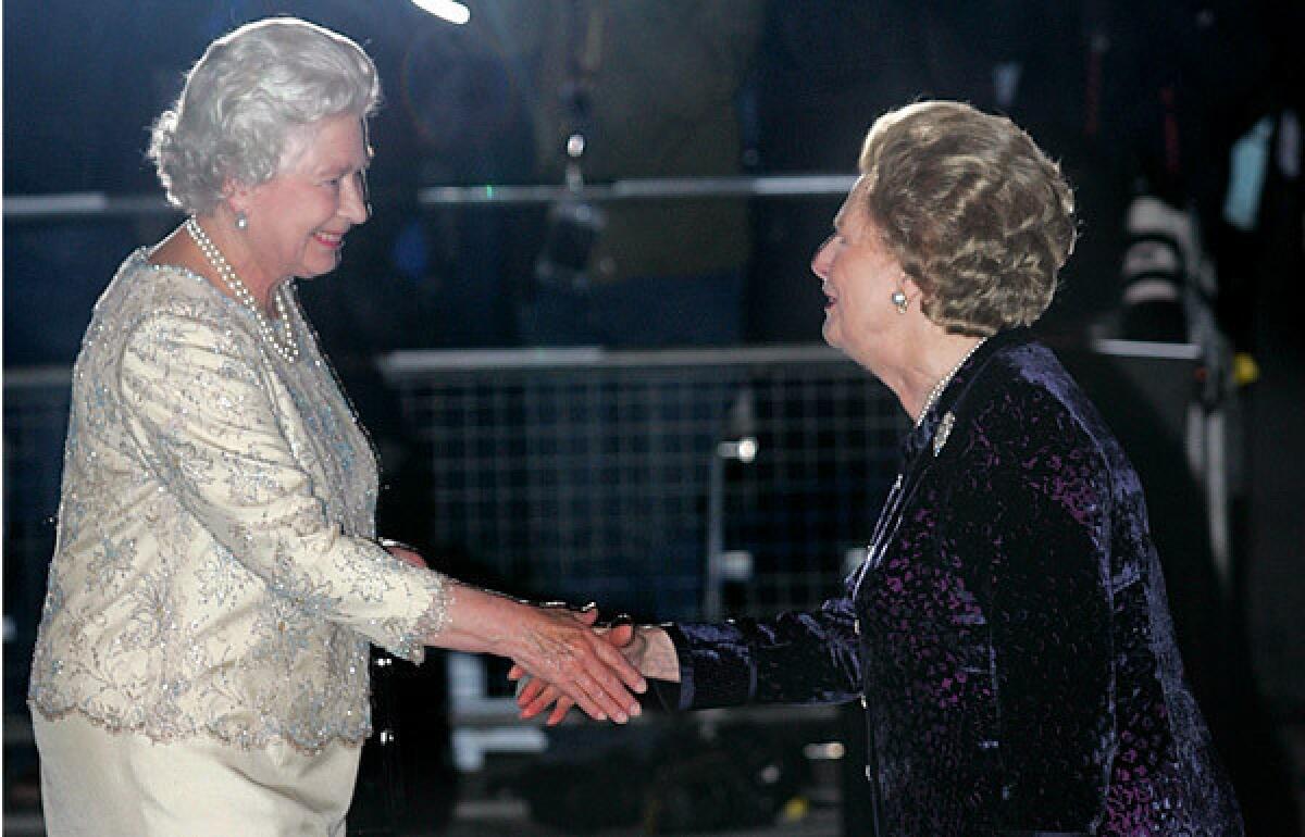 Former British Prime Minister Margaret Thatcher, right, greets Queen Elizabeth II as she arrives for Thatcher's 80th birthday party at the Mandarin Oriental Hotel in London.