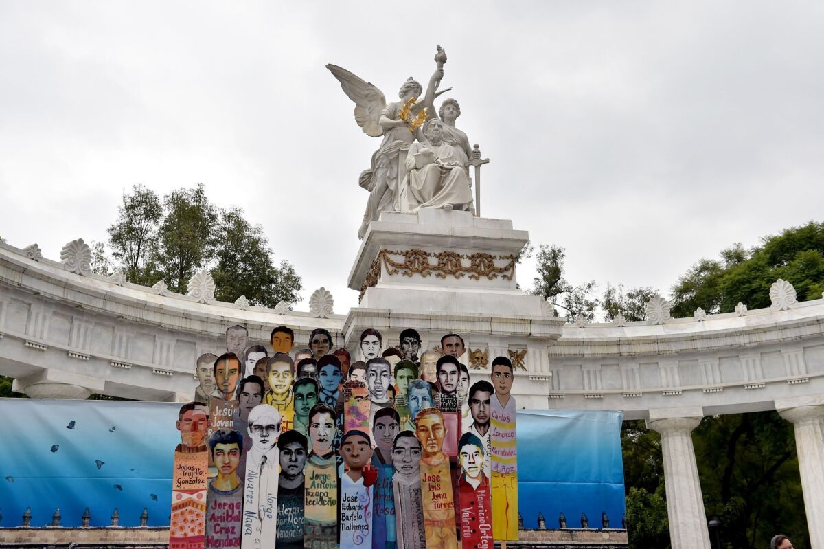 Banners representing the 43 missing students are seen during a protest in Mexico City on Sept. 26. The faces of the 43 have become a broader symbol of everyday Mexicans held hostage to the country's violence.