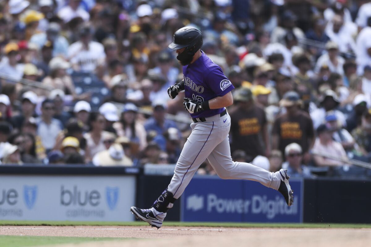 Colorado Rockies' Chris Owings rounds third base after hitting a solo home run off San Diego Padres relief pitcher Craig Stammen in the seventh inning of a baseball game Sunday, July 11, 2021, in San Diego. (AP Photo/Derrick Tuskan)