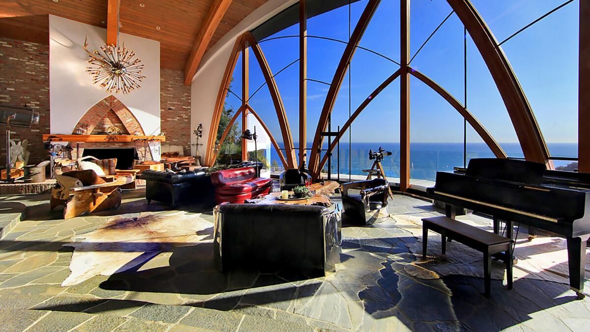 A grand, arched window defines a Malibu hills home by architect Harry Gesner.