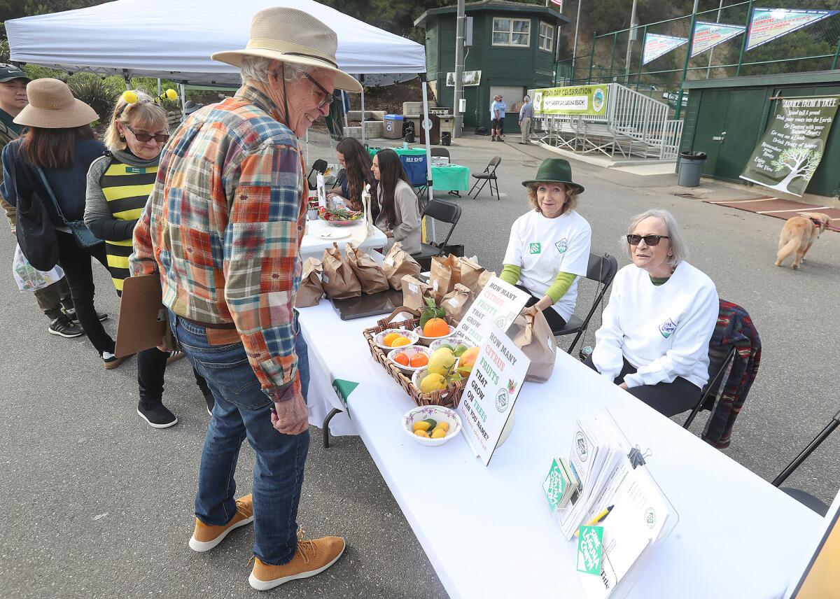 Cheryl Czyz and Linda Mayer of Laguna Canyon Conservancy answer questions at their table display on Thursday.