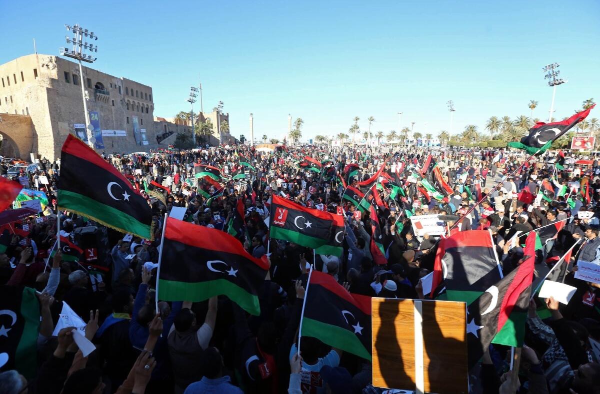 Libyans wave their national flag as they demonstrate Friday against the General National Congress, the country's highest political authority.