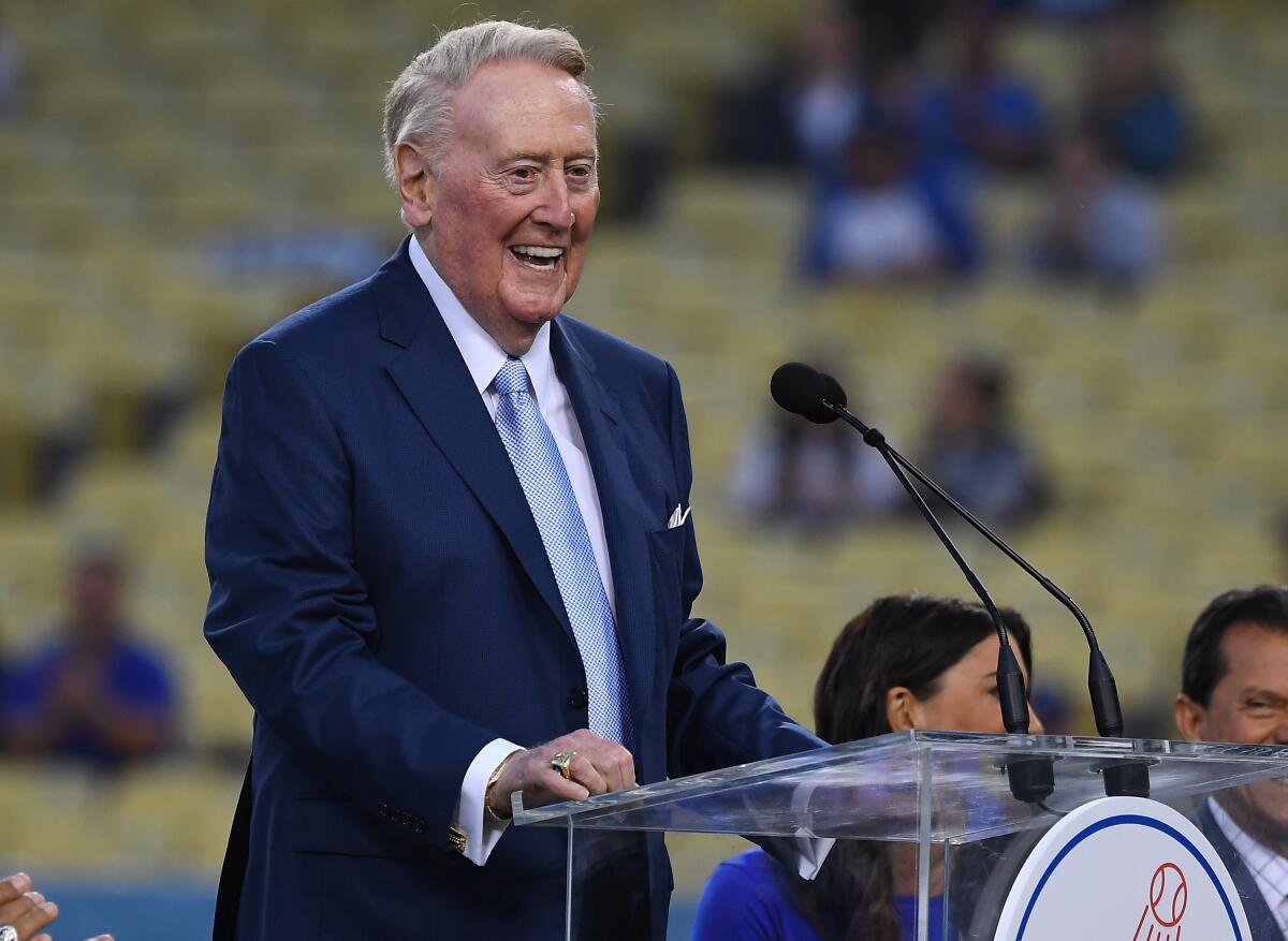 Retired Dodgers broadcaster Vin Scully, left speaks during a pregame ceremony at Dodger Stadium on Sept. 21, 2018.