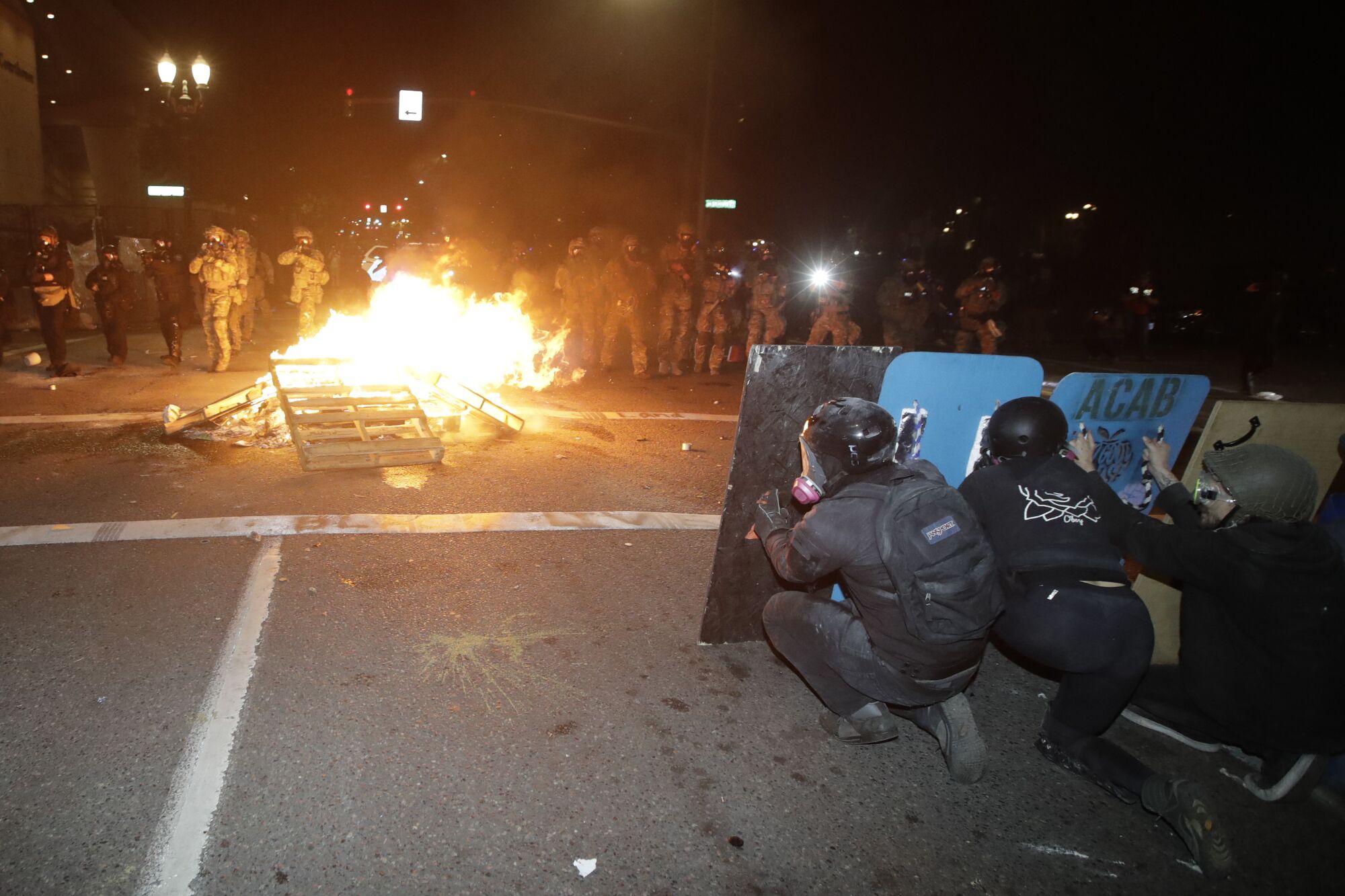 Federal officers advance on protesters during a Black Lives Matter demonstration in Portland, Ore.