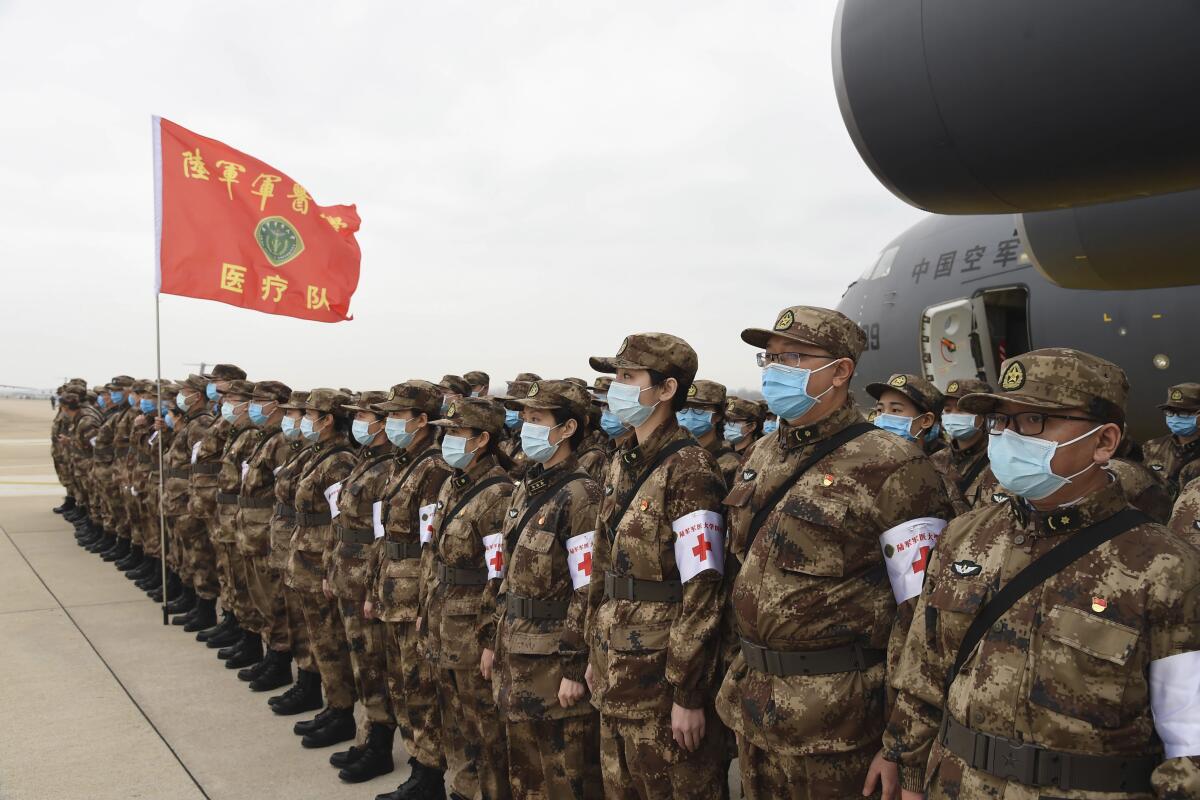 Chinese military medics arrive at the Tianhe International Airport in Wuhan on Thursday.